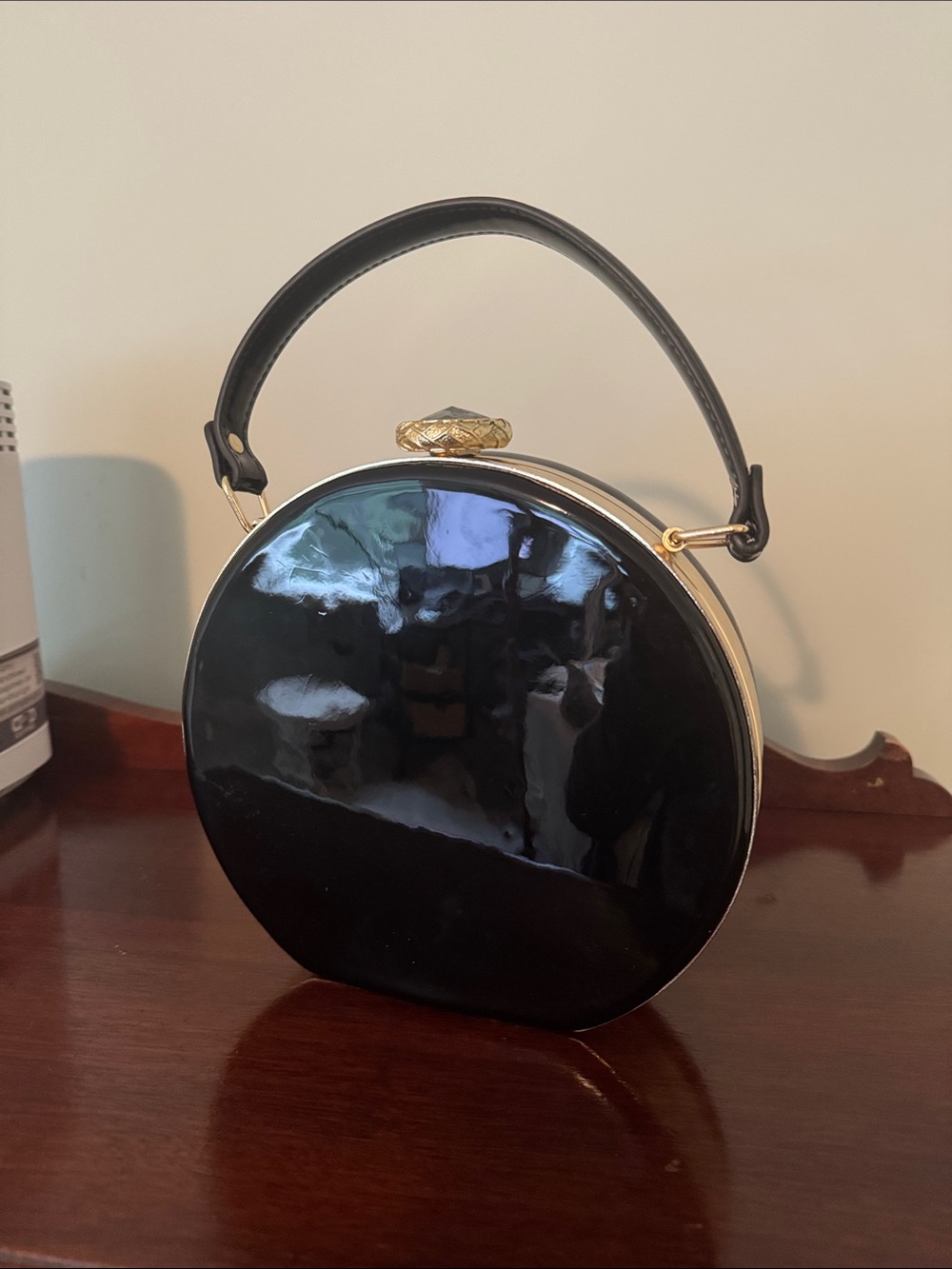 Glossy Black Patent Round Top-Handle Clutch with large emerald clasp